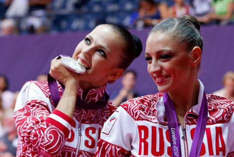 Silver medallist Russia's Daria Dmitrieva celebrates with gold medallist compatriot Evgeniya Kanaeva in the individual all-around gymnastics final victory ceremony at the Wembley Arena